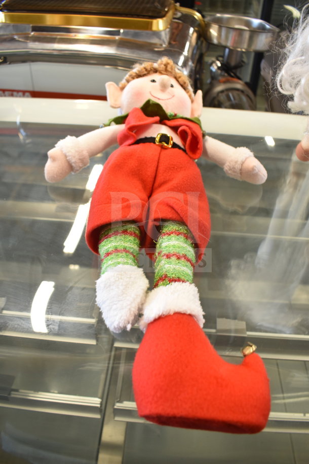 Lot with plush elf doll in red outfit, curly hair, and striped socks. Features jingle bell on shoe. In good condition.