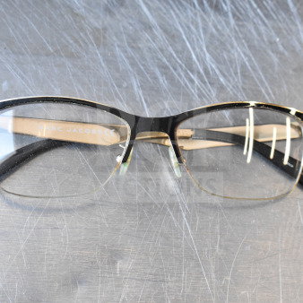Marc Jacobs black and gold eyeglasses in good condition, featuring a logo on the temples and sturdy frame construction.