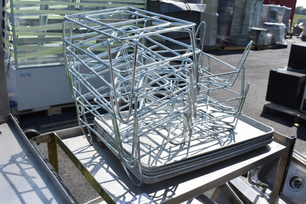 2 tier metal cart with multiple baking pans stacked on the bottom shelf, in used condition, outdoors.