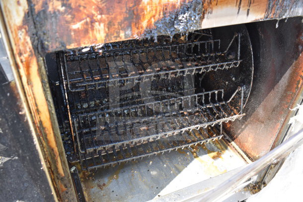 Fri-jado TDR7+7 P rotisserie oven interior with visible racks, showing signs of use. 208 volts, 3 phase electric.