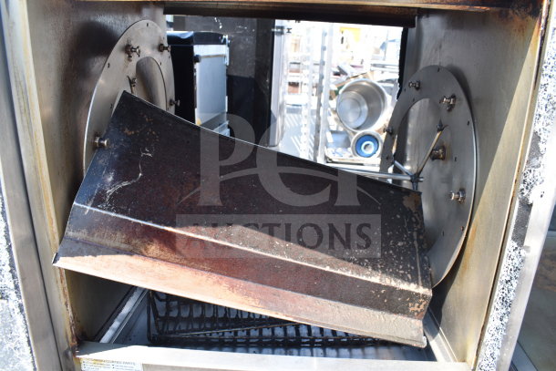 Commercial rotisserie oven with interior view, missing doors, used condition, visible signs of wear and missing components.