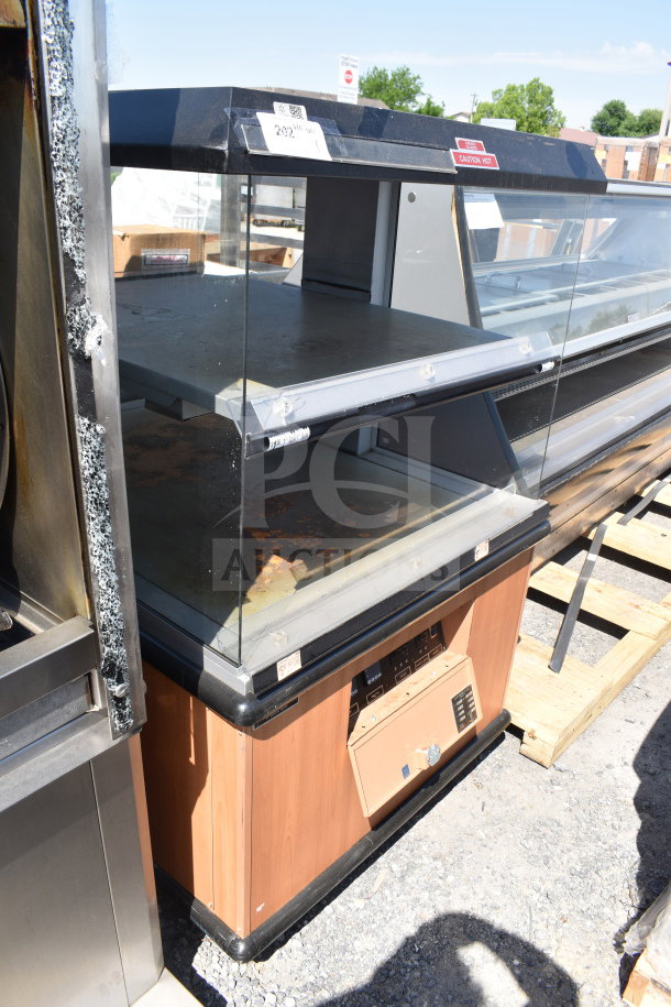 Custom Deli's Inc commercial heated display case merchandiser, 120/208 volts, 1 phase, glass panels, wood finish, visible wear.
