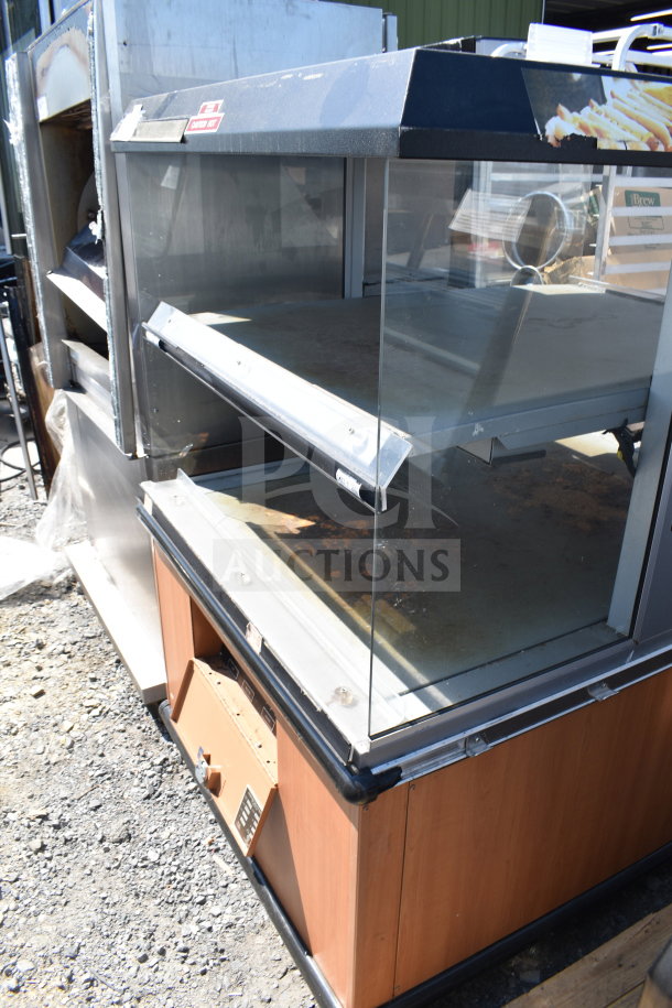 Custom Deli's Inc commercial heated display case, 120/208V, 1 phase. Features dual shelves and glass panels. Used condition.