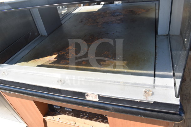 Custom Deli's Inc heated display case, commercial grade, 120/208 volts, 1 phase, visible wear, control panel intact.
