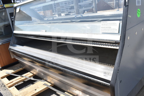 Commercial floor-style display case merchandiser with glass front, metal shelving, and visible allergy notice. Good condition.