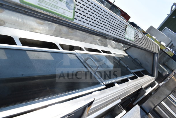 Commercial floor style display case merchandiser, metallic body, glass doors, ventilation holes, used condition.