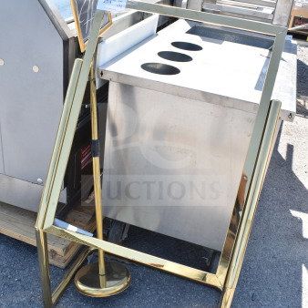 Gold sign frame with attached sign, featuring a sturdy base. Appears in good condition. Auction tag visible.