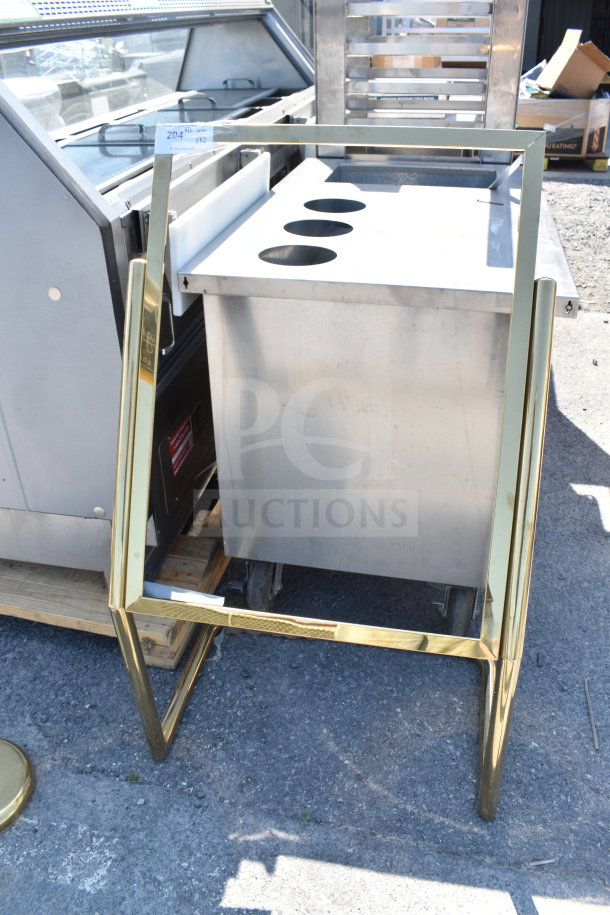Golden metal sign frame outdoors, leaning against stainless steel equipment. Tag visible, labeled "204".