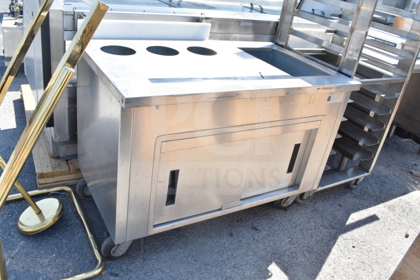 Delfield SC-50-NU commercial 50" serving counter with solid top and enclosed base, stainless steel, on wheels.