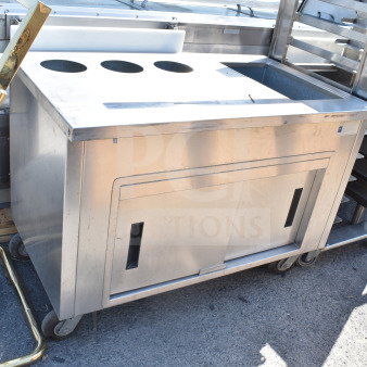 Delfield SC-50-NU commercial 50" serving counter with solid top and enclosed base, stainless steel, on wheels.