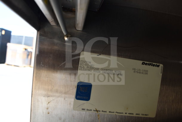 Delfield SC-50-NU serving counter with solid top, enclosed base. Label shows model, date 06-13-1996, NSF certification.