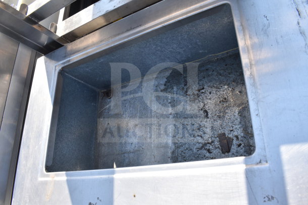 Delfield SC-50-NU 50" commercial serving counter with enclosed base, solid top, and visible wear on interior.