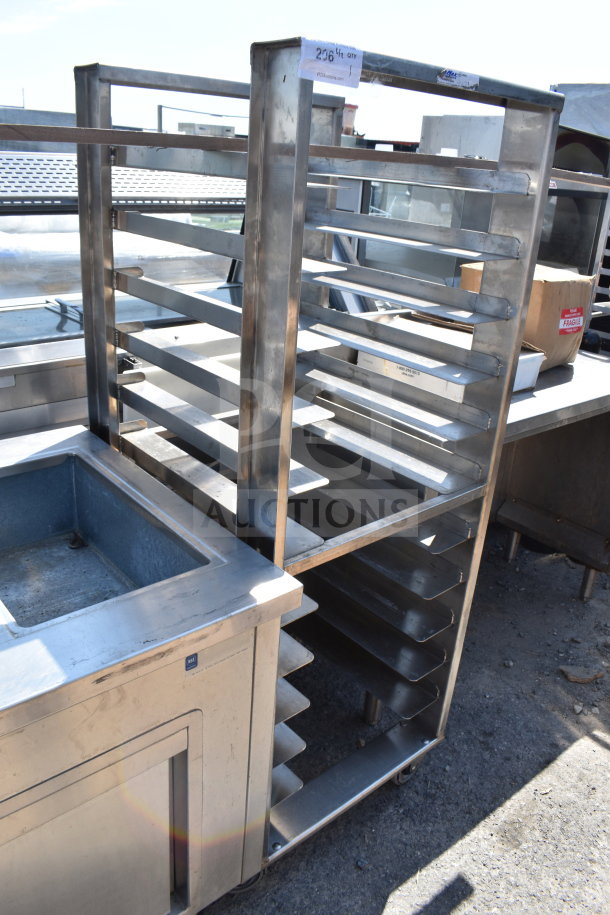 Commercial pan transport rack with multiple shelves, stainless steel frame, and commercial casters. Good condition.