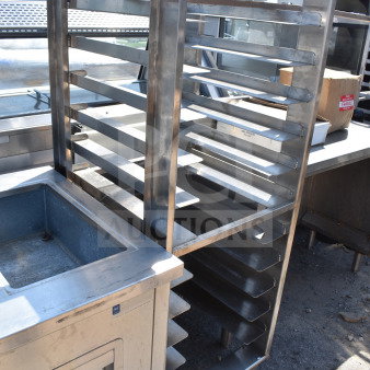 Commercial pan transport rack with multiple shelves, stainless steel frame, and commercial casters. Good condition.