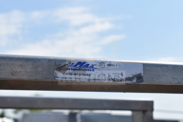 Commercial pan transport rack on casters with metal frame. Label shows "AllMax Equipment," contact info, and NSF certification.