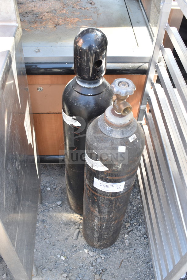 Two black nitrogen tanks with visible wear and valve caps, labels indicate 3365 PSI. Pickup only, no shipping.