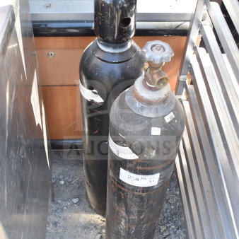 Two black nitrogen tanks with visible wear and valve caps, labels indicate 3365 PSI. Pickup only, no shipping.