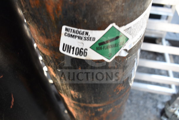 Two compressed nitrogen tanks with labels displaying "Nitrogen, Compressed" and "UN1066" markings. Buyer pickup required.