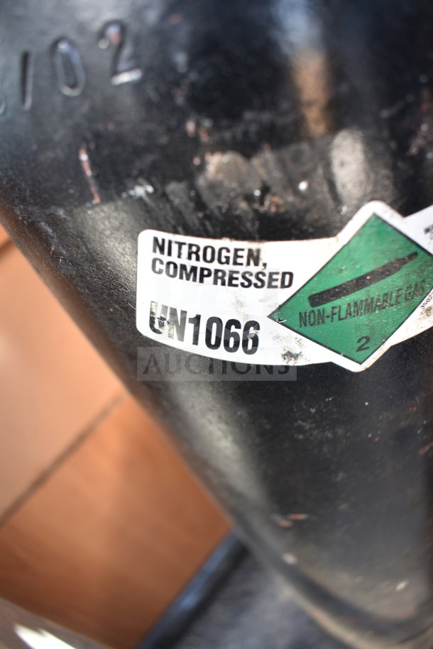 Compressed nitrogen tank with label indicating UN1066, non-flammable gas. Buyer pickup required.