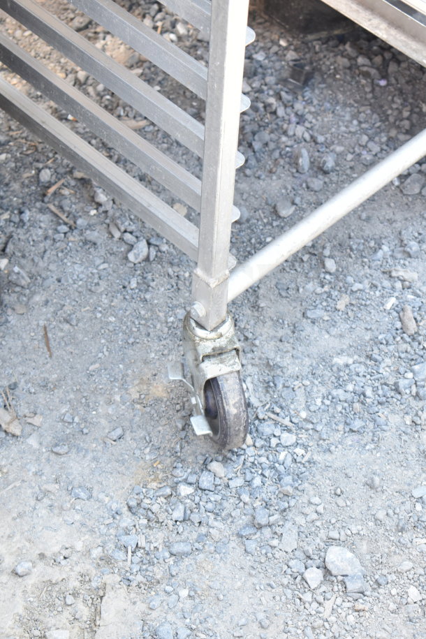 Commercial pan transport rack with stainless steel shelving and durable commercial casters. In used condition.