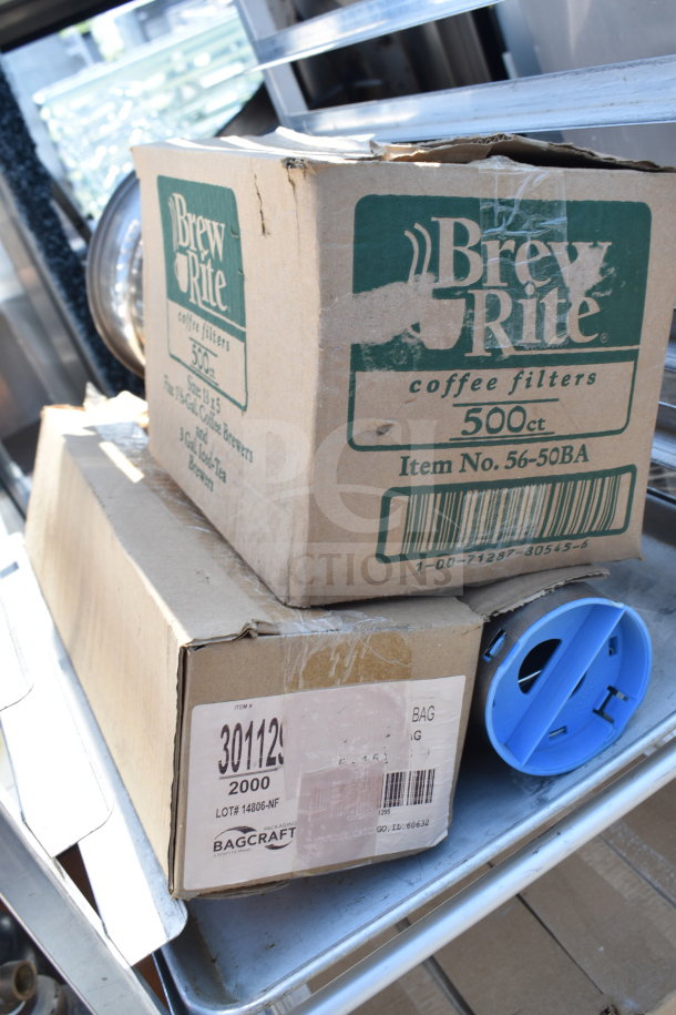 Commercial pan transport rack with metal shelves and casters, holding boxes of Brew Rite coffee filters and Bagcraft packaging.