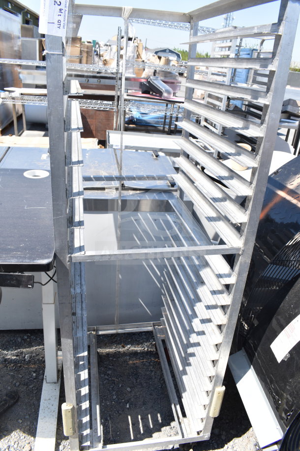 Commercial pan transport rack on sturdy casters, featuring multiple shelves for efficient storage. Used condition.