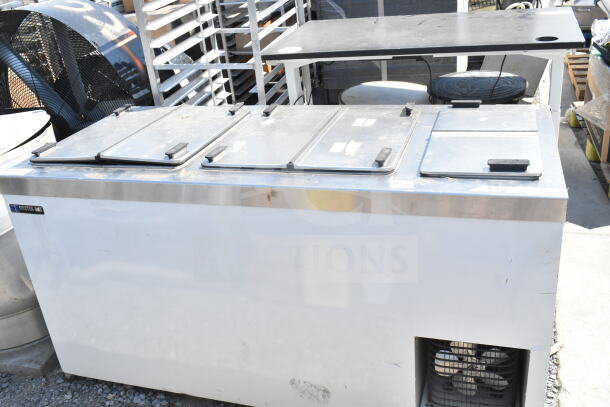 Master-Bilt commercial chest freezer, 115 volts, 1 phase, with metal exterior, four compartments. Visible brand label.