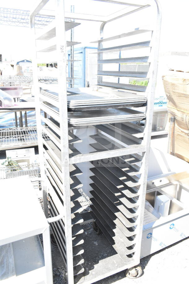 Commercial pan transport rack with multiple shelves on sturdy commercial casters. Good condition, ideal for bakeries.