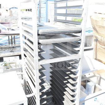 Commercial pan transport rack with multiple shelves on sturdy commercial casters. Good condition, ideal for bakeries.