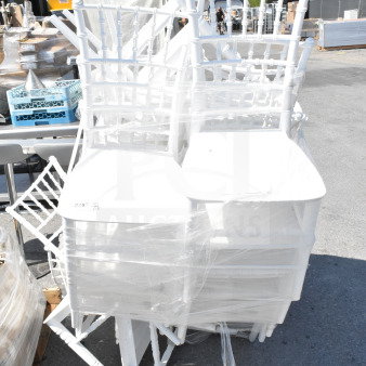 White wood Chiavari chairs by Lancaster Table & Seating, scratch and dent, wrapped in plastic, stacked on palette.