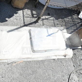 Lot of various items including Tuxton bowls, baking pan, and shelf liners on a concrete surface. Some items in boxes.