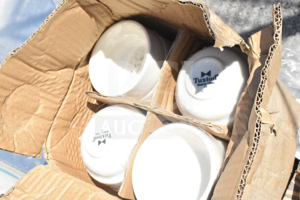 Box of four Tuxton white porcelain bowls, marked "Made in China," with visible wear, in a corrugated cardboard box.
