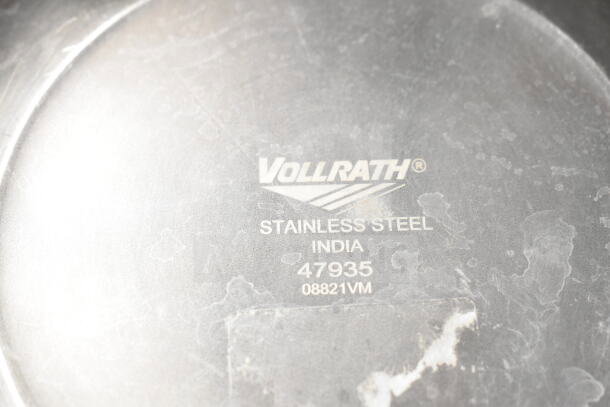 Stainless steel Vollrath bowl made in India, model 47935, visible wear, part of a set including metal bowls and drop-in bin.