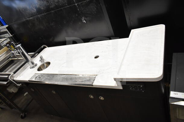 Modern portable bar with marble countertop, integrated sink, and chrome tap dispenser. Good condition. Ideal for events.