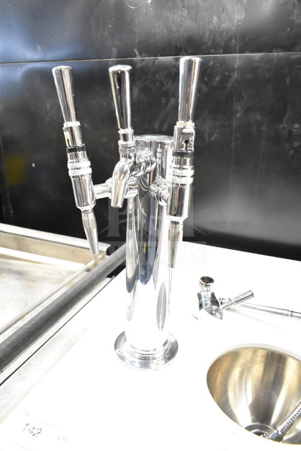 Chrome portable bar with multiple beer taps on a sturdy base, designed for easy beverage dispensing.