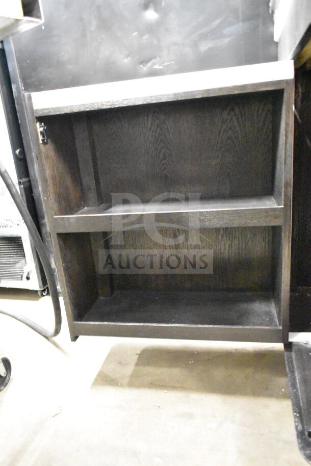 Black wooden portable bar with open shelving, visible hinges, and a modern design. Suitable for home or event use.