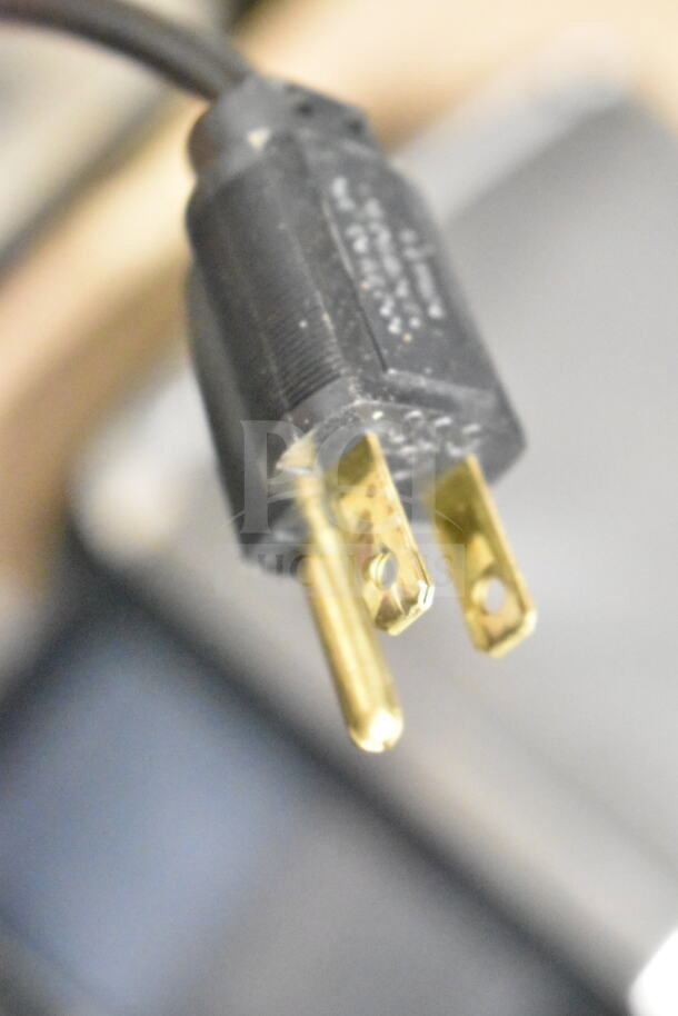 Close-up of a power plug for the 2017 Hobart HTi-7LH26 food portioning scale.