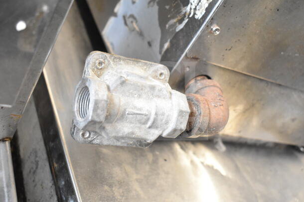 Close-up of a gas connection on a Cecilware Pro Commercial Countertop Gas Charbroiler Grill, showing rust and wear.