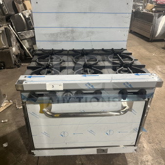 Kutano 36" 6-burner stainless steel range/oven, model KUT6BRN36N6, new with scratches. Natural gas-powered, includes wired rack.