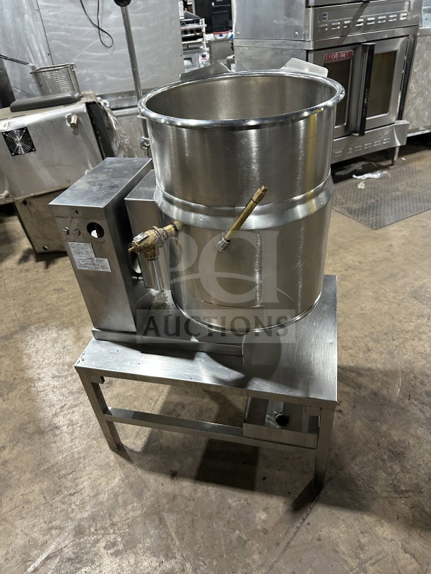 Commercial stainless steel electric tilting steam-jacketed kettle on legs, excellent condition, with brass valve and control box.