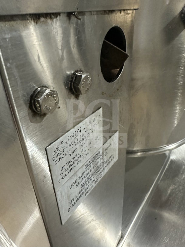 Wow Commercial stainless steel electric tilting steam-jacketed kettle, on legs, with visible label and bolts.