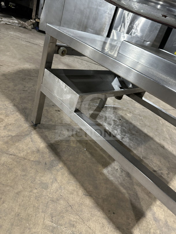 Wow Commercial stainless steel electric tilting steam-jacketed kettle on legs, sturdy build, industrial use.