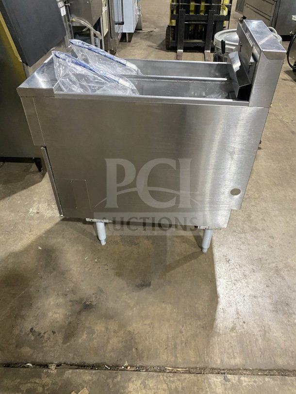 Pitco SE14T commercial stainless steel deep fat fryer with back splash, basket hanger, new fry basket, and individual controls on legs.