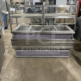 Atlas Metal Industries stainless steel refrigerated cold pan table with sneeze guard and sliding door storage. On casters.
