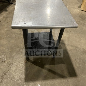 Commercial stainless steel work table with lower shelf, rectangular top, moderate wear, auction tag "46". Ideal for equipment.