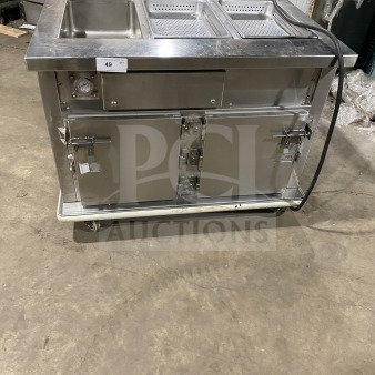 Commercial stainless steel hot food table with integrated heated cabinet, on casters. Features dual basins and locking doors.