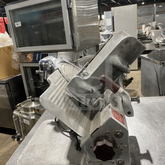 Globe 660 commercial electric deli meat slicer, on legs, with adjustable thickness knob. Serial number 674425. Good condition.