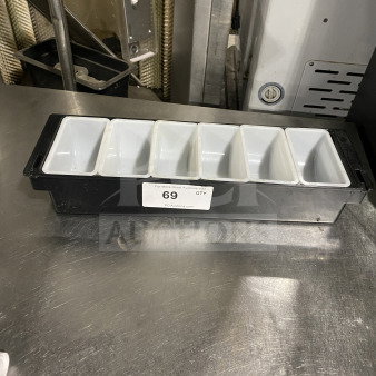 Commercial plastic 6-compartment condiment dispenser, black with white inserts, label reads "69, PCI Auctions."