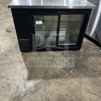 True commercial stainless steel refrigerated beer cabinet, model TBB-24-48G-SD-LD. Features view-through sliding doors, stainless worktop, and poly-coated wire rack. Serial number 87664332. 115V, 1 Phase.