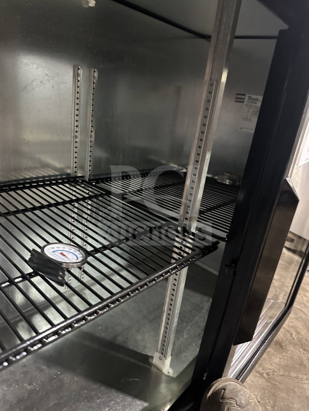 True commercial stainless steel beer fridge, Model TBB-24-48G-SD-LD, with glass sliding doors and poly-coated racks.